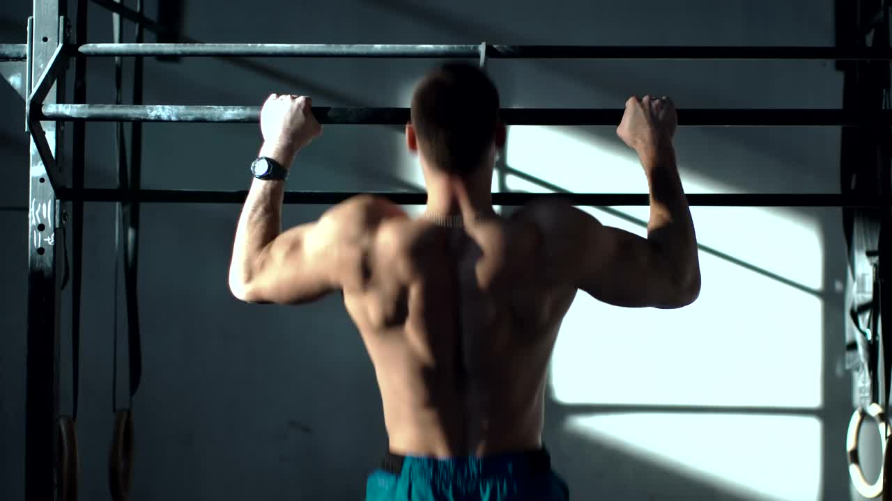 Stock Video Man Training On The Bars In The Gy Animated Wallpaper
