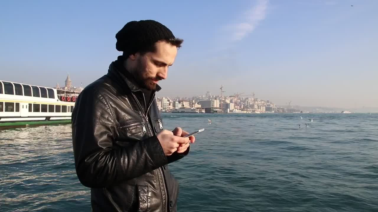 Stock Video Man Texting In The Coas Animated Wallpaper