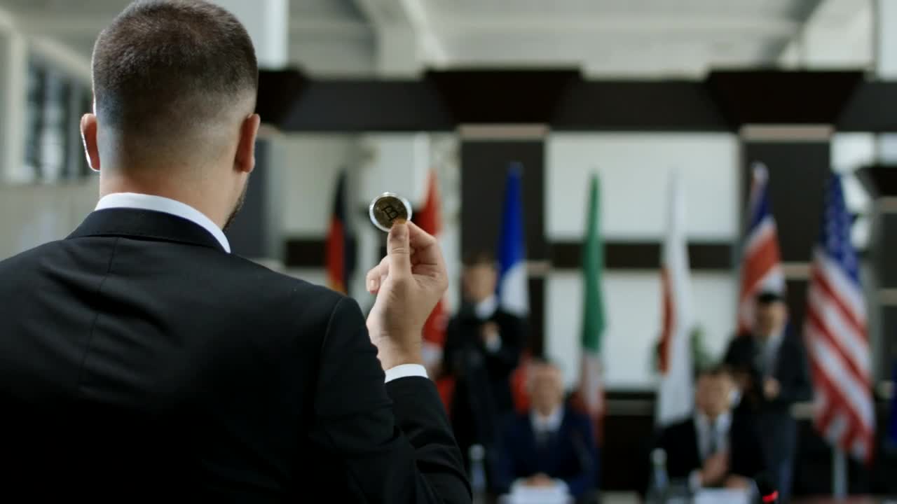 Stock Video Man Talking With A Coin In His Han Animated Wallpaper