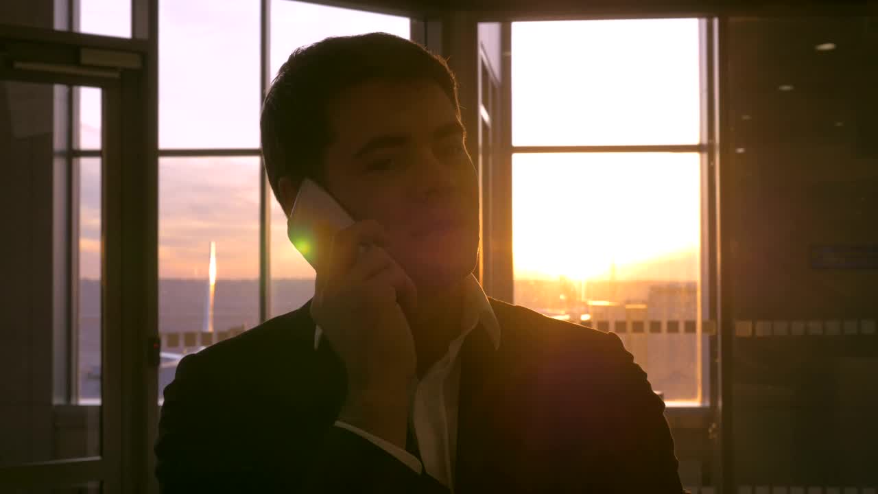 Stock Video Man Talking On The Phone Before Boarding A Fligh Animated Wallpaper