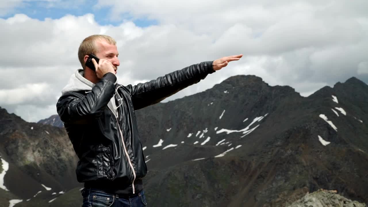 Stock Video Man Talking On Cell Phone In A Mountain Rang Animated Wallpaper