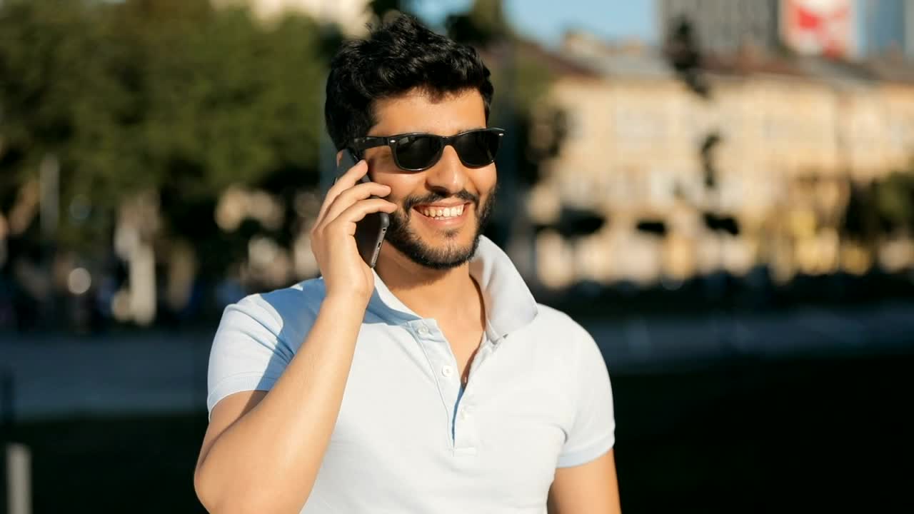 Stock Video Man Talking On Cell Phone At Downtow Animated Wallpaper