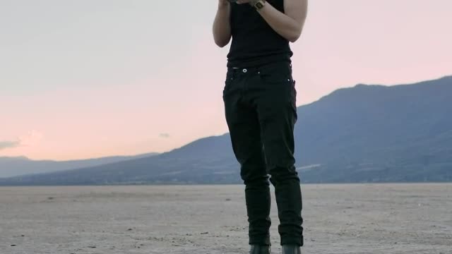 Stock Video Man Taking Photos In The Middle Of A Large Desert Sma Animated Wallpaper