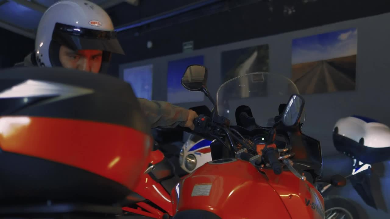 Stock Video Man Taking A Motorcycle Out Of A Worksho Animated Wallpaper