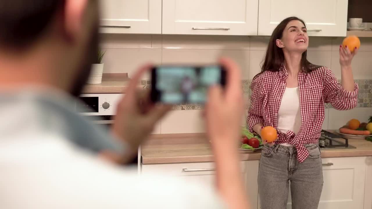 Stock Video Man Takes Social Media Photo Of Woman On Mobile I Animated Wallpaper