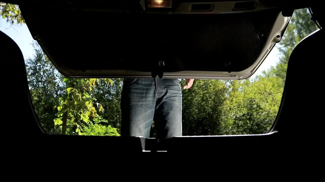 Stock Video Man Taking A Hazard Triangle From His Trun Animated Wallpaper