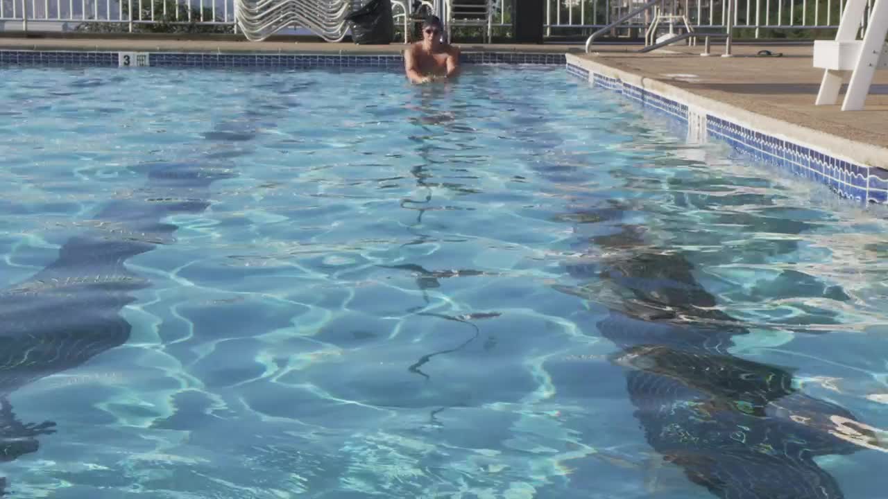 Stock Video Man Swimming In An Outdoor Poo Animated Wallpaper