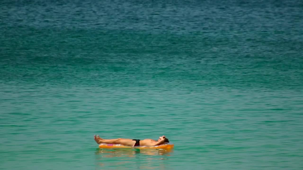 Stock Video Man Sunbathing In The Ocea Animated Wallpaper