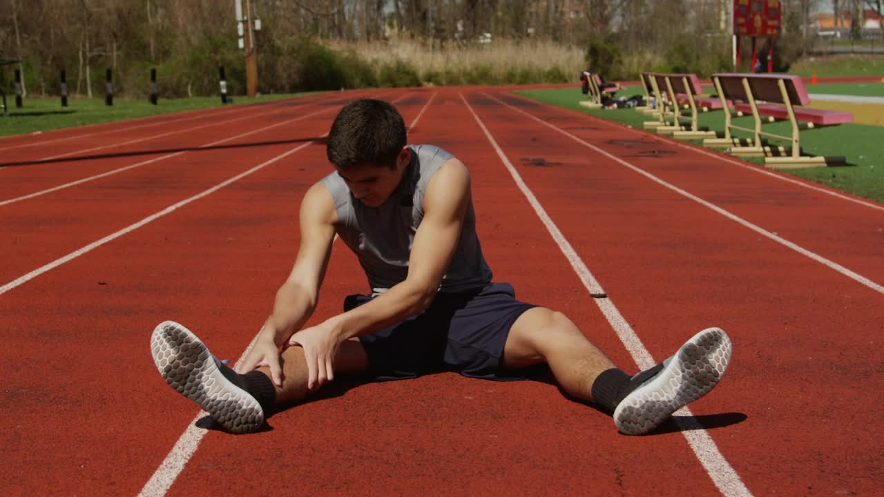 Stock Video Man Stretching At A Running Trac Animated Wallpaper