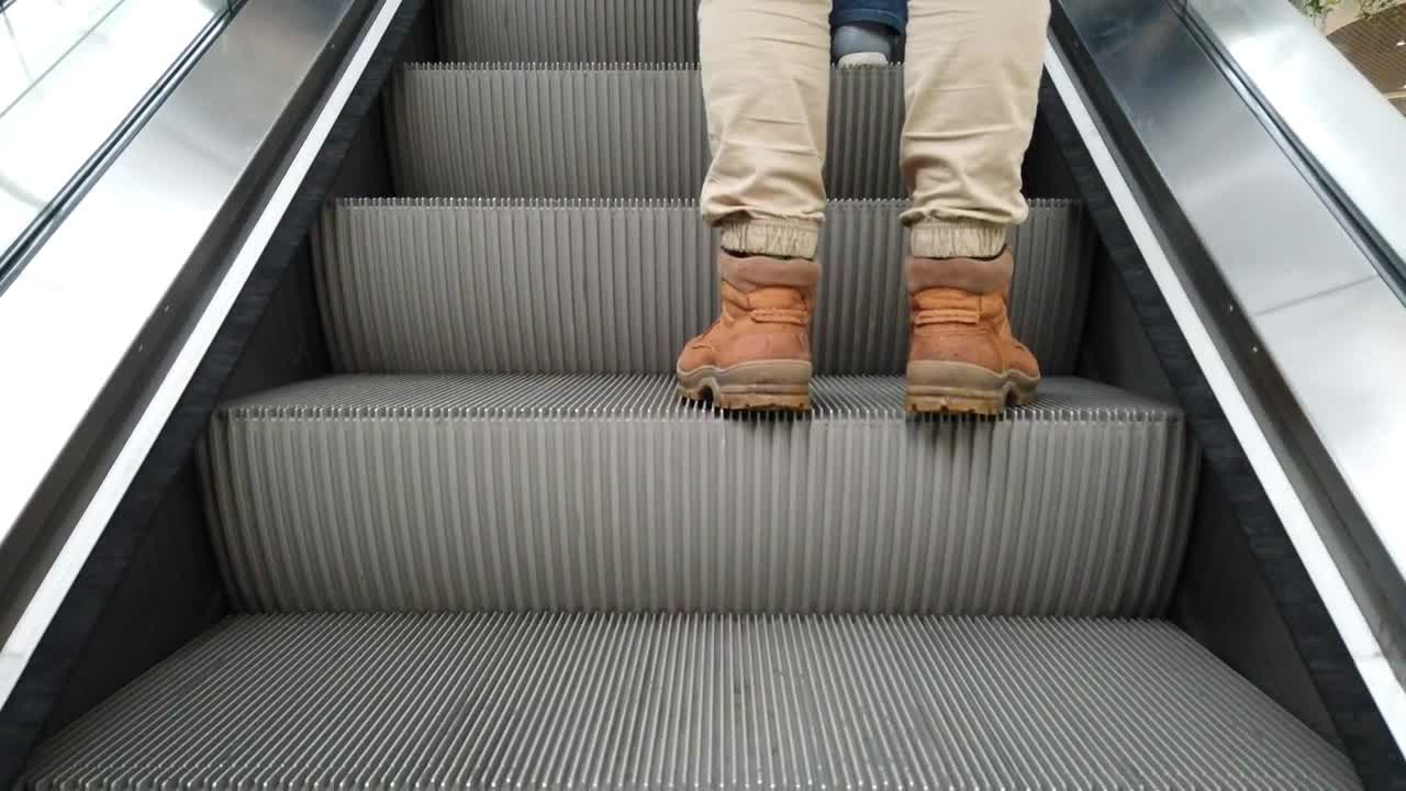 Stock Video Man Standing On An Escalato Animated Wallpaper