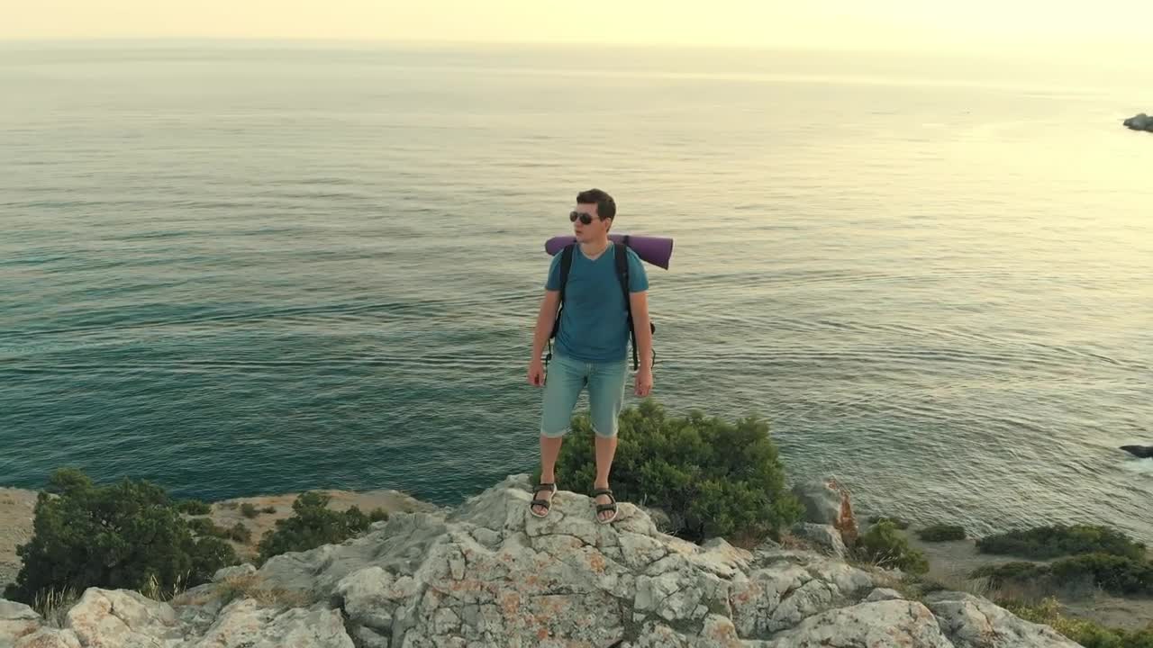Stock Video Man Standing On A Cliff Facing The Se Animated Wallpaper