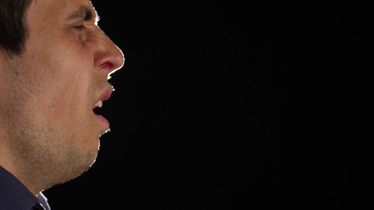 Stock Video Man Sneezing With Dark Backgroun Animated Wallpaper