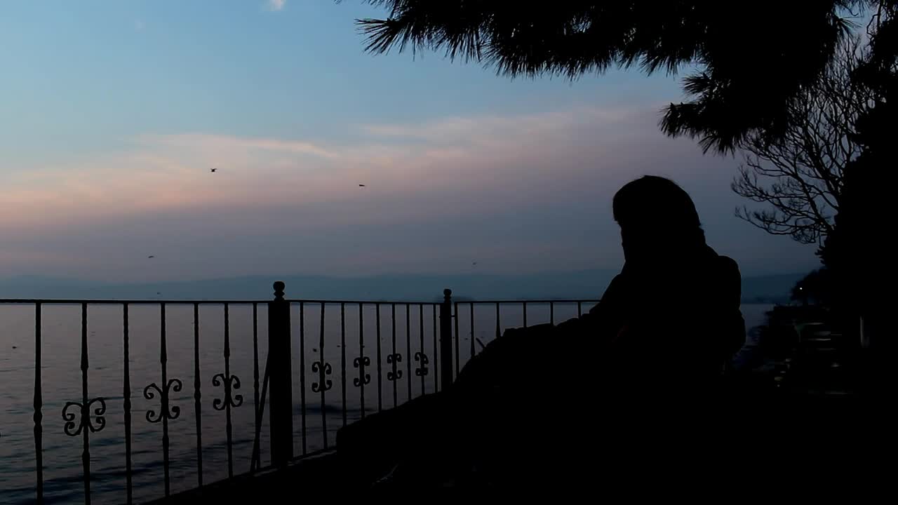 Stock Video Man Smoking On The Seashore At Dus Animated Wallpaper