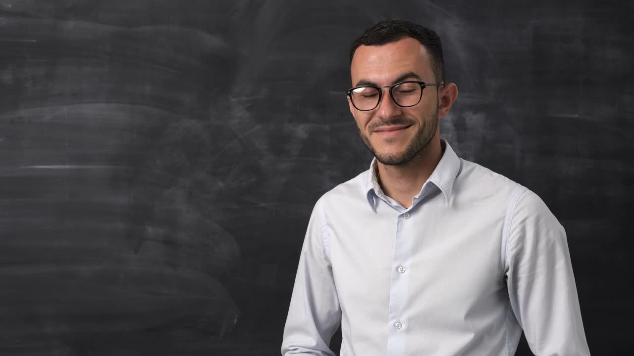 Stock Video Man Smiling By A Blackboar Animated Wallpaper