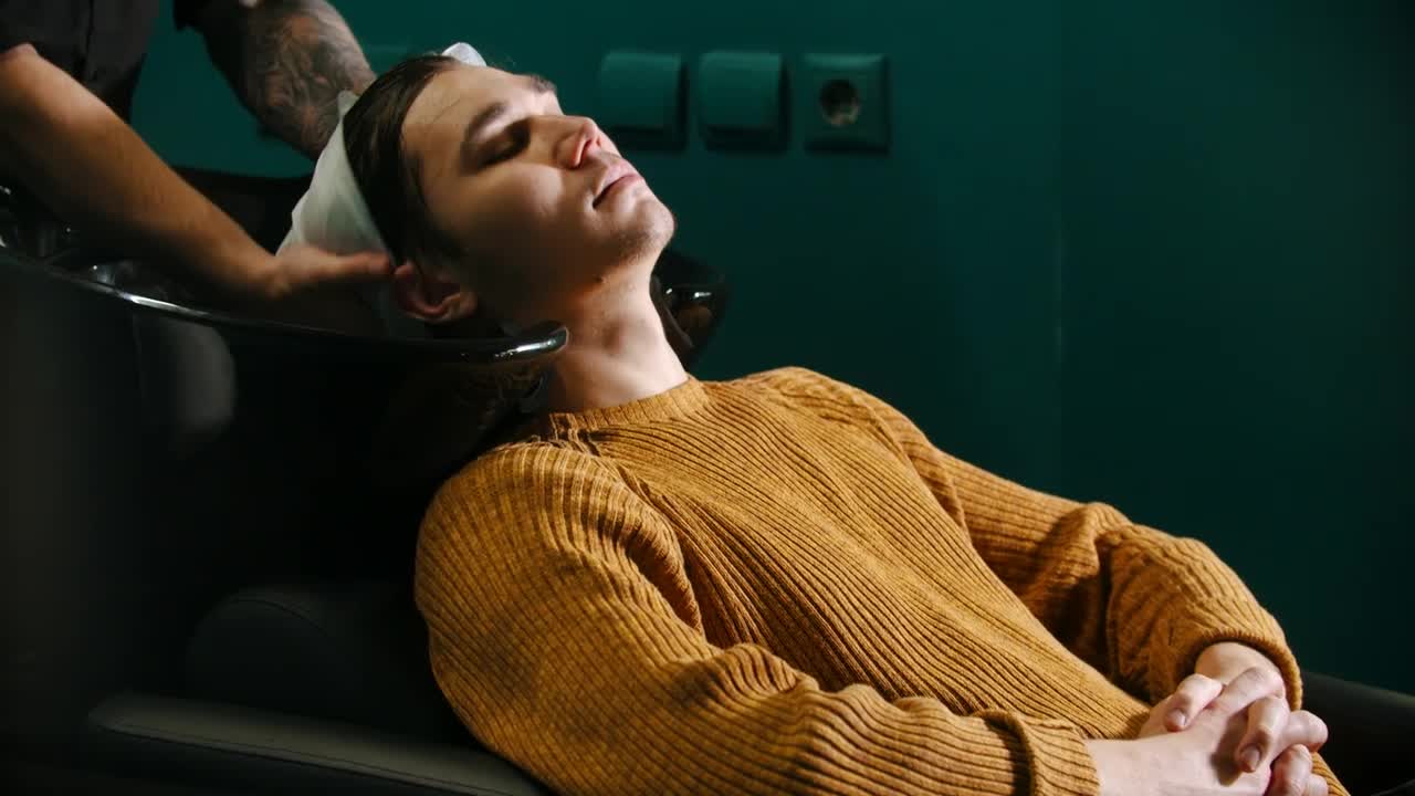 Stock Video Man Sitting While Having His Hair Washe Animated Wallpaper