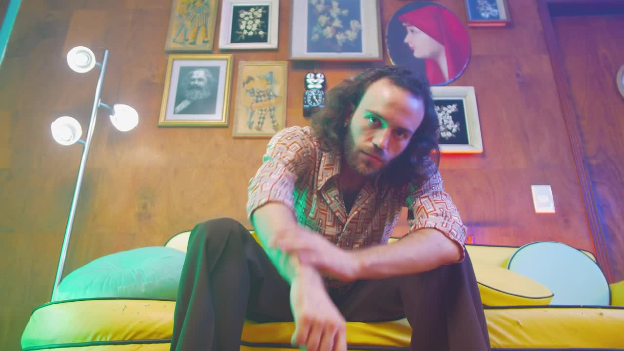 Stock Video Man Sitting On The Sofa And Looking At The Camer Animated Wallpaper