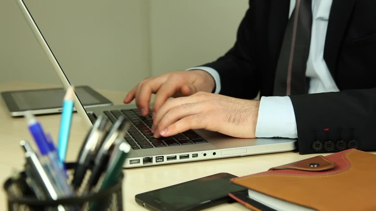 Stock Video Man Sitting On A Couch Working On A Lapto Animated Wallpaper