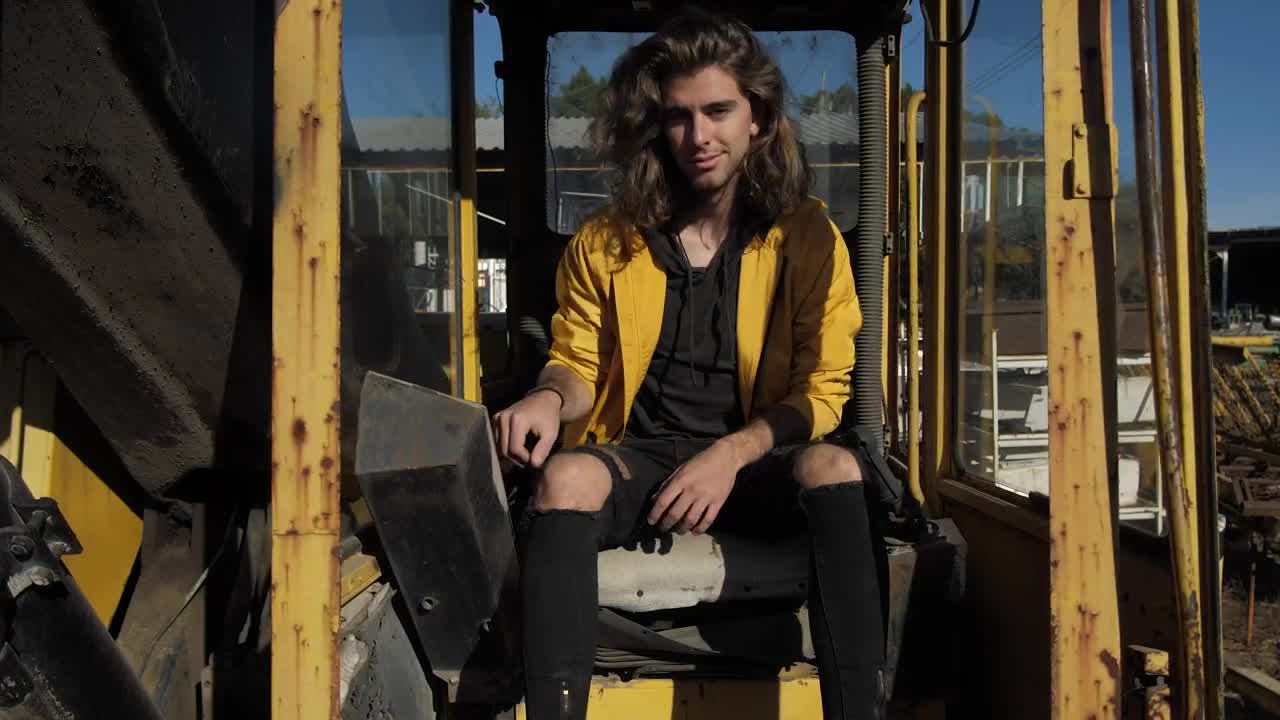 Stock Video Man Sitting Among Yellow Rusty Tube Animated Wallpaper