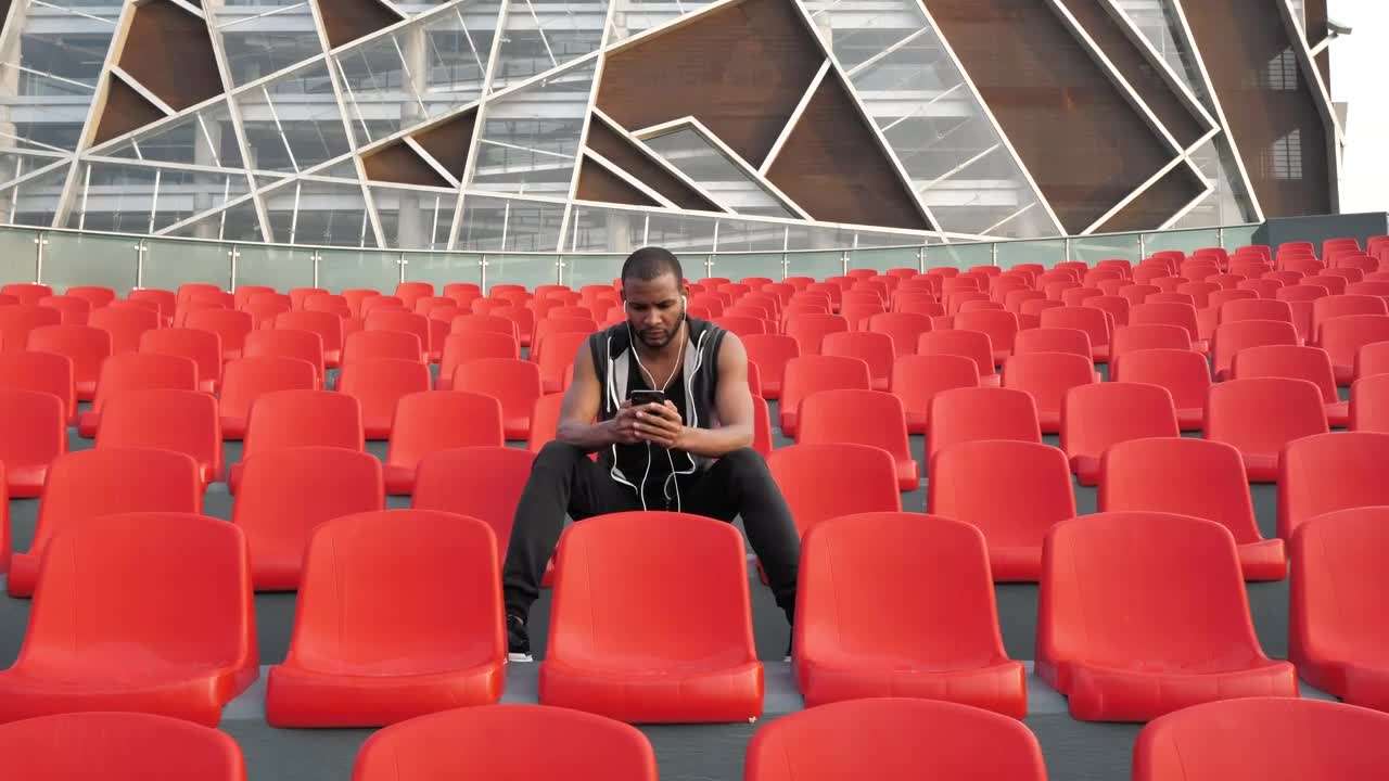 Stock Video Man Sits In Orange Chair Listening To Musi Animated Wallpaper