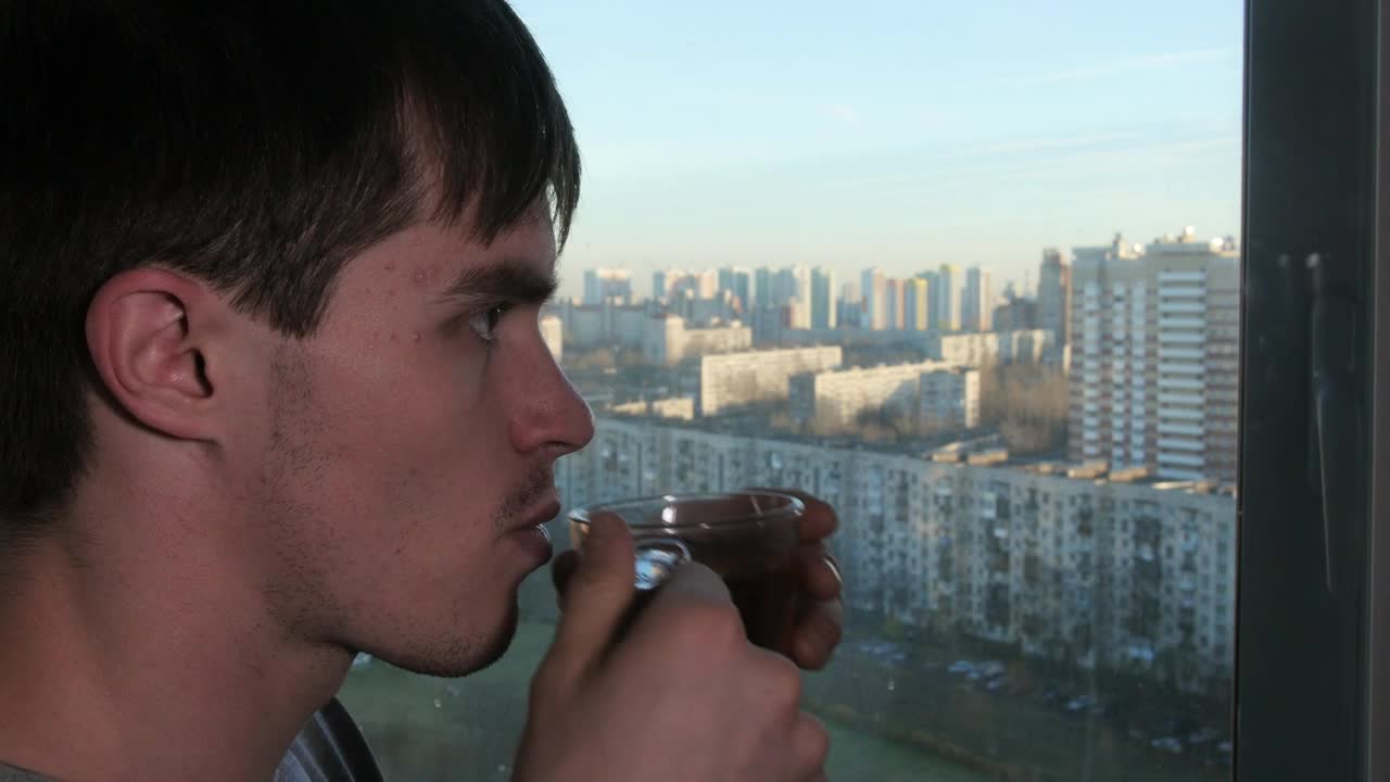 Stock Video Man Sipping Tea By The Windo Animated Wallpaper