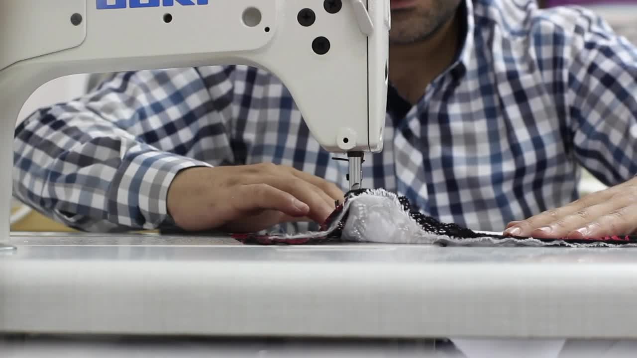 Stock Video Man Sewing A Garment On A Sewing Machin Animated Wallpaper
