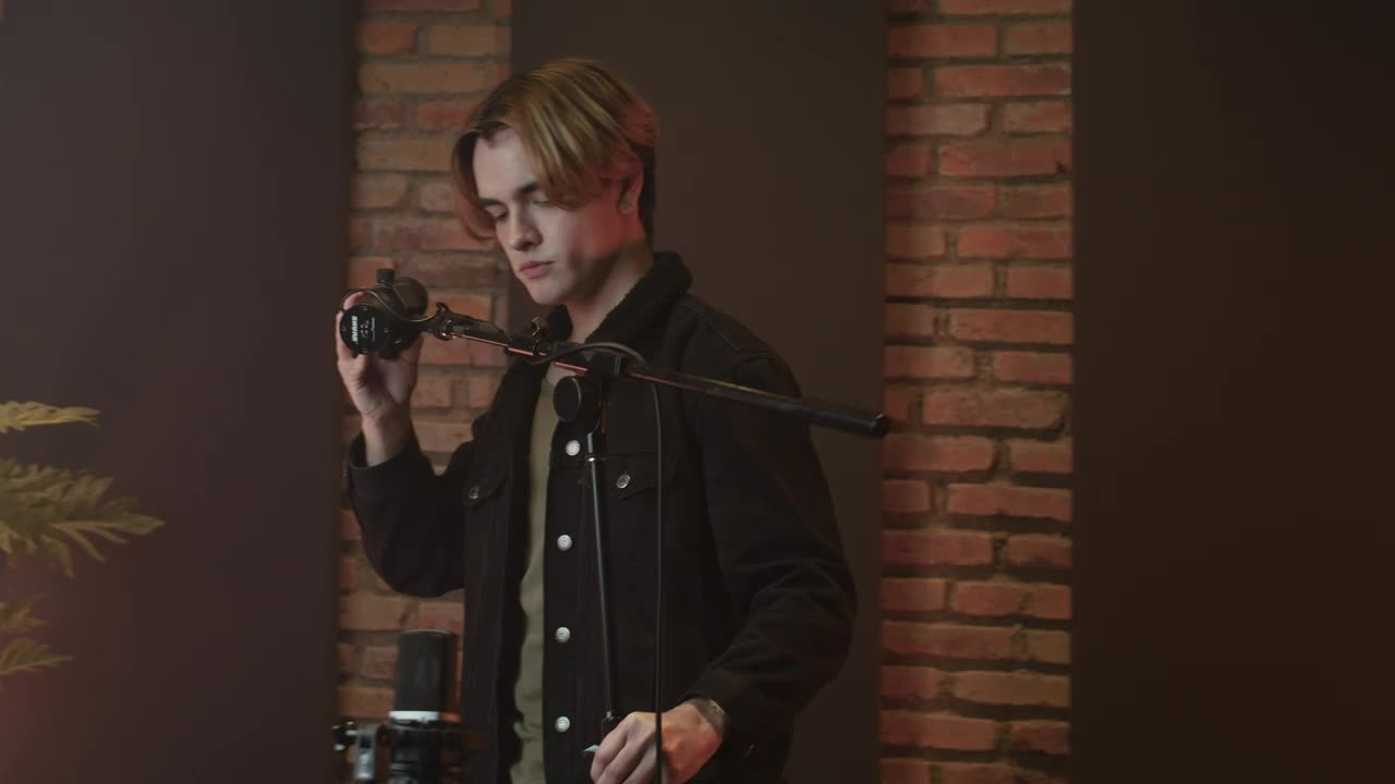 Stock Video Man Setting Up His Microphon Animated Wallpaper