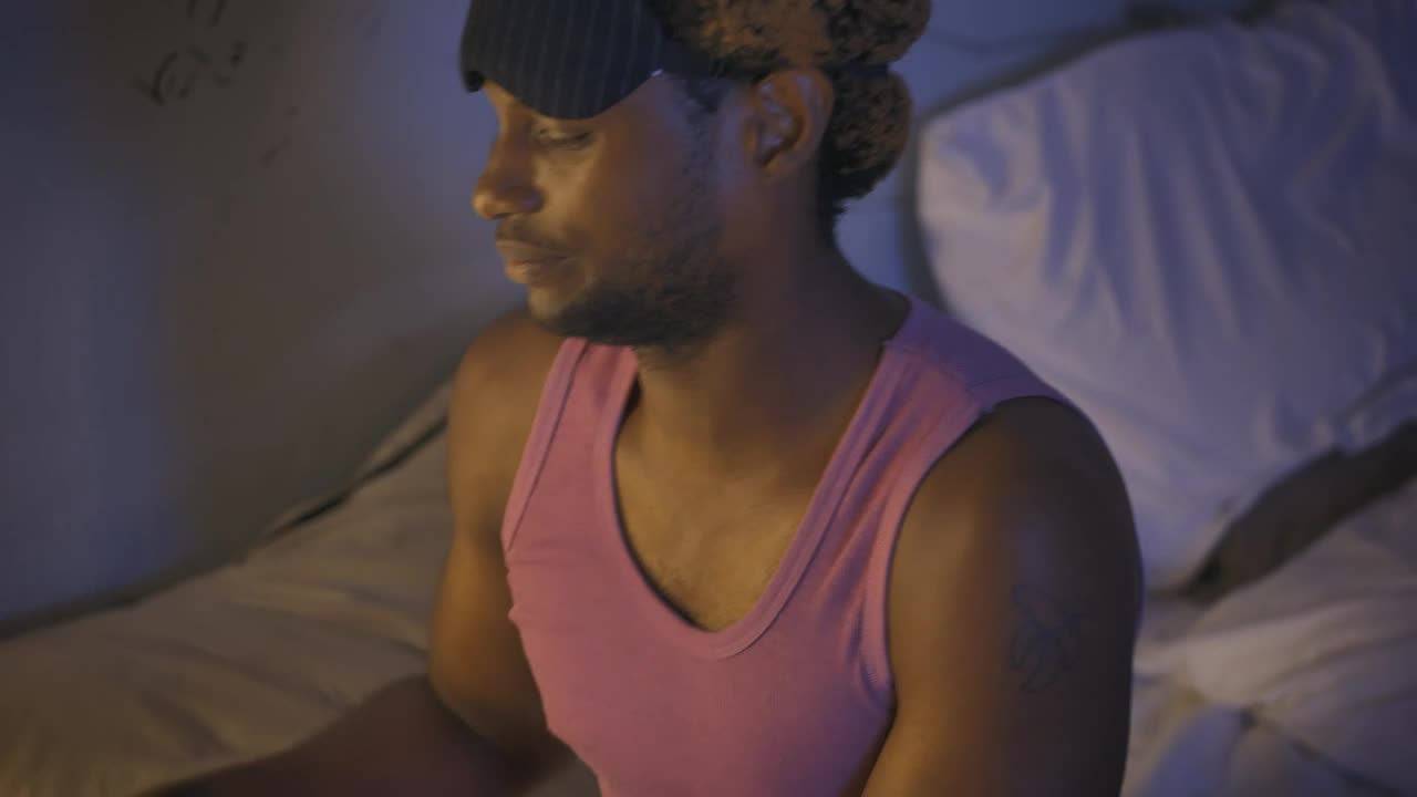 Stock Video Man Setting His Alarm Clock Before Going To Slee Animated Wallpaper