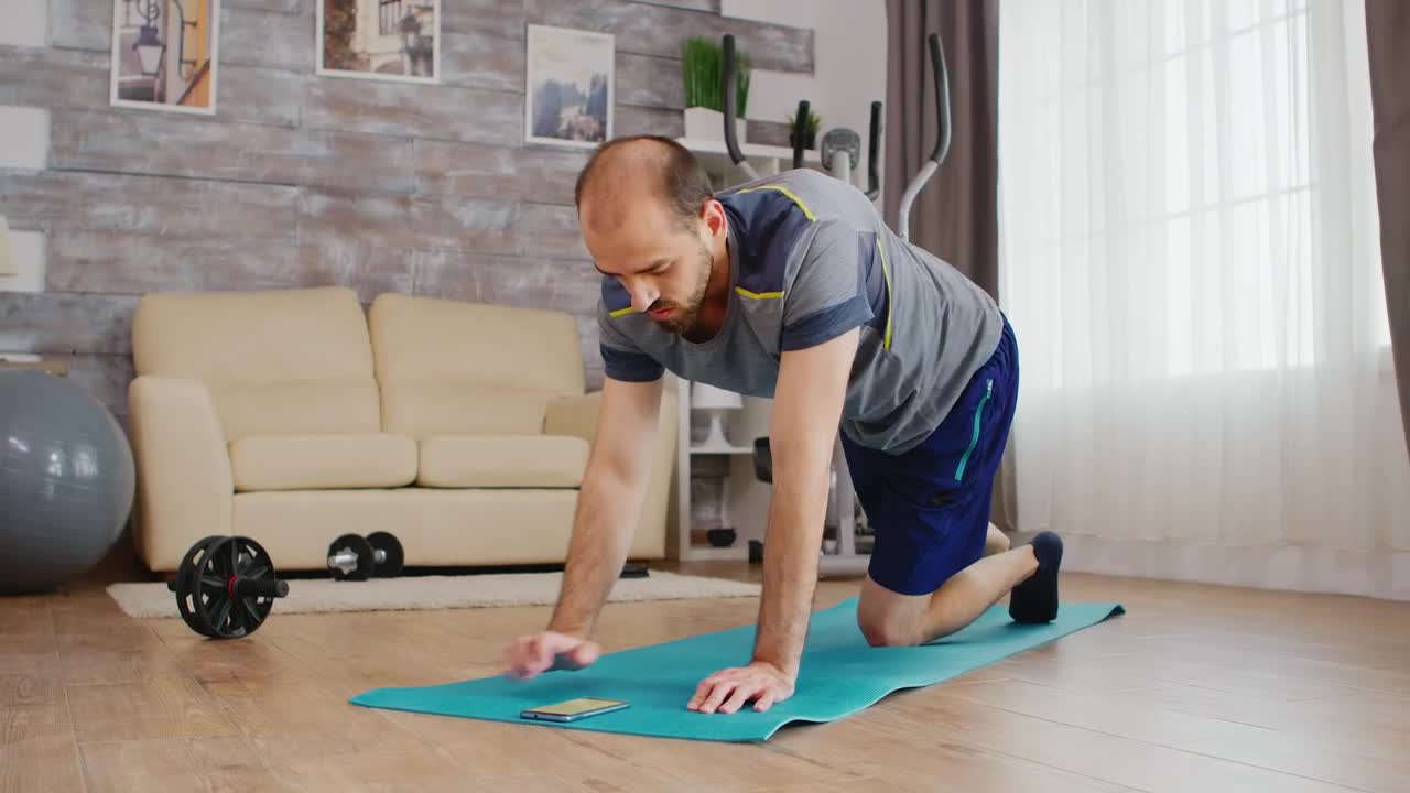 Stock Video Man Sets Exercise Timer On Mobile Phone For Yoga Pos Animated Wallpaper