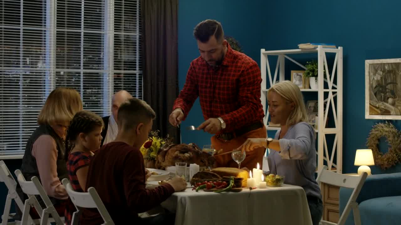 Stock Video Man Serving The Turkey For His Famil Animated Wallpaper