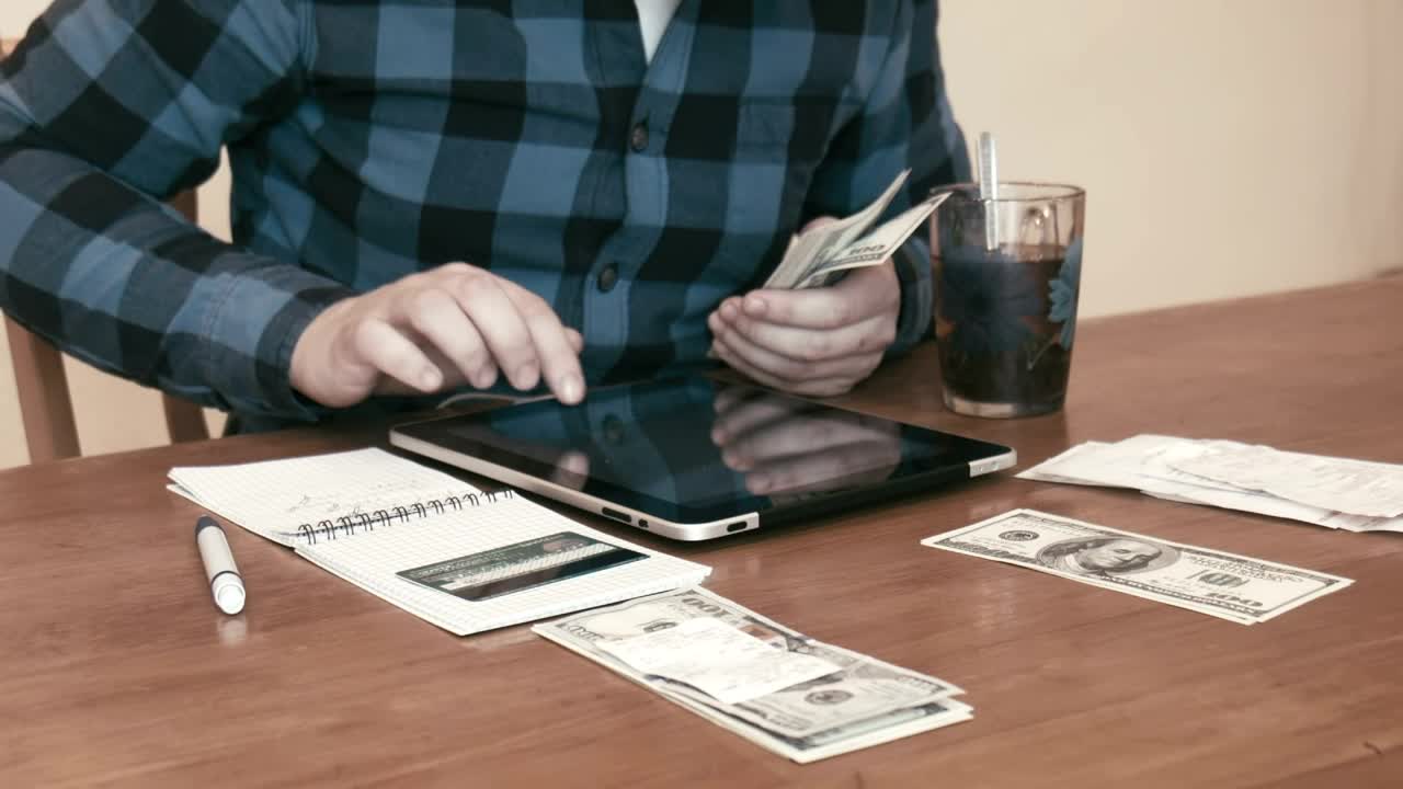 Stock Video Man Separating Money For Different Budget Animated Wallpaper