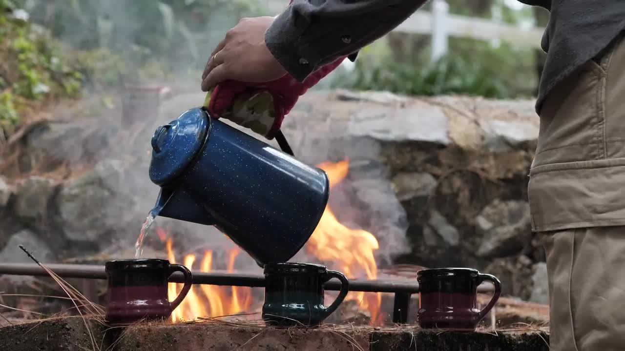 Stock Video Man Serving Hot Water In The Fores Animated Wallpaper