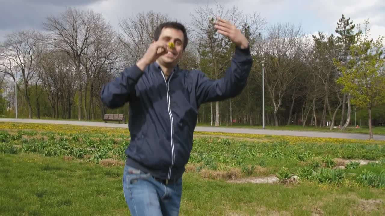 Stock Video Man Runs Happy With A Flower In The Par Animated Wallpaper