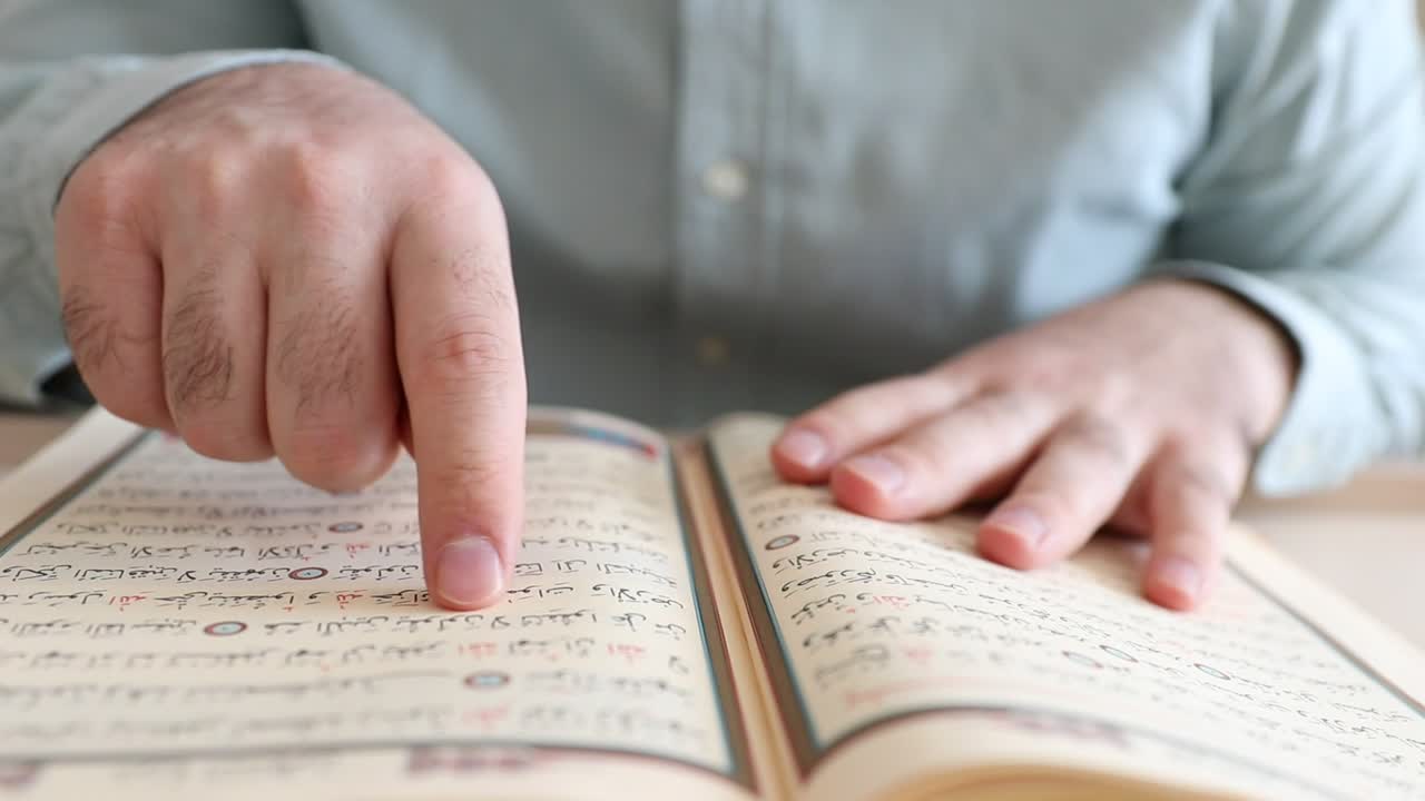 Stock Video Man Running His Finger On The Pages Of The Qura Animated Wallpaper