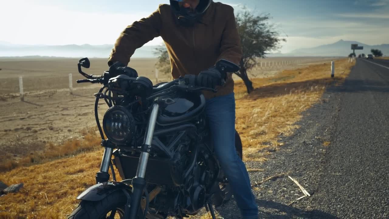 Stock Video Man Riding His Motorcycle On The Side Of A Roa Animated Wallpaper