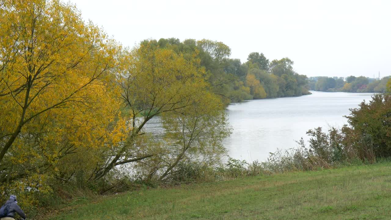 Stock Video Man Riding His Bike By The Rive Animated Wallpaper