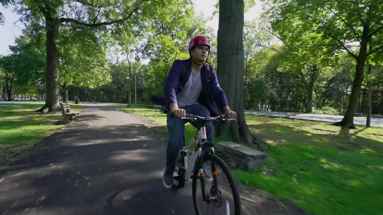 Stock Video Man Riding A Bike Through The Par Animated Wallpaper