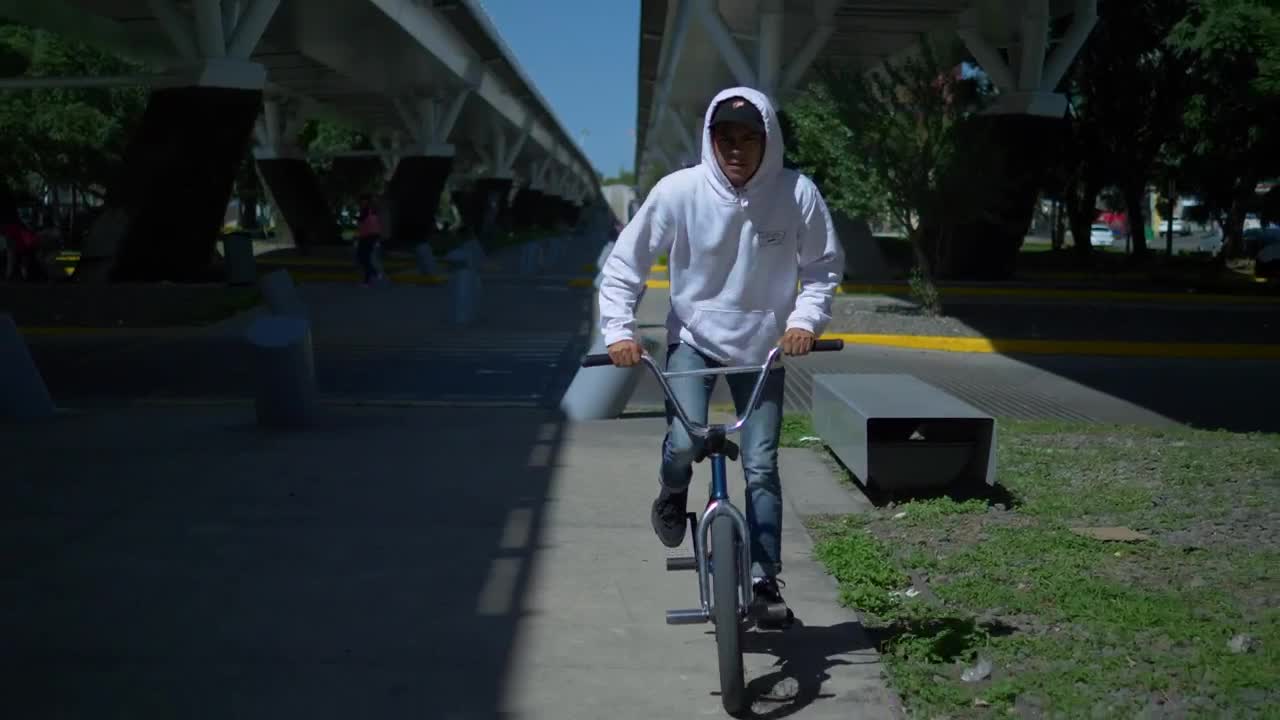 Stock Video Man Rides Bicycle Under Suspended Bridg Animated Wallpaper