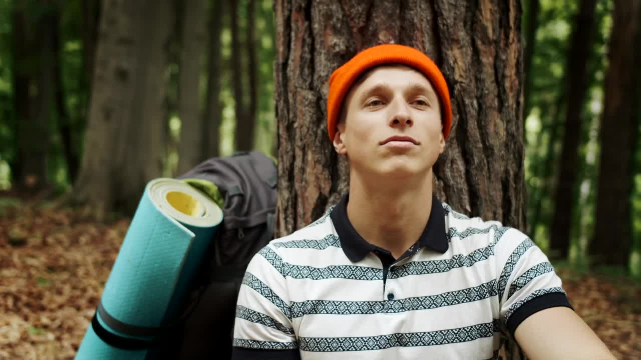 Stock Video Man Resting In A Forest With Hopeful Attitud Animated Wallpaper