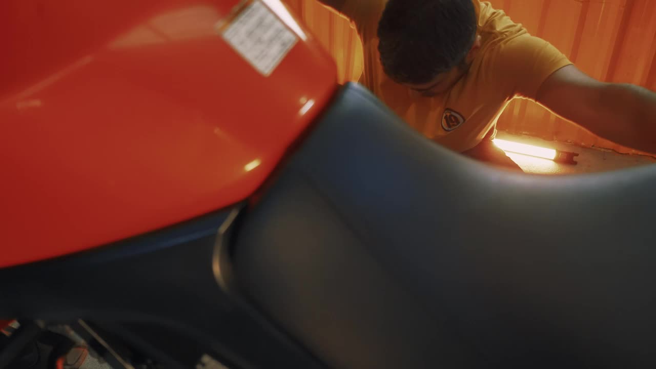 Stock Video Man Repairing His Motorcycle In A Garag Animated Wallpaper