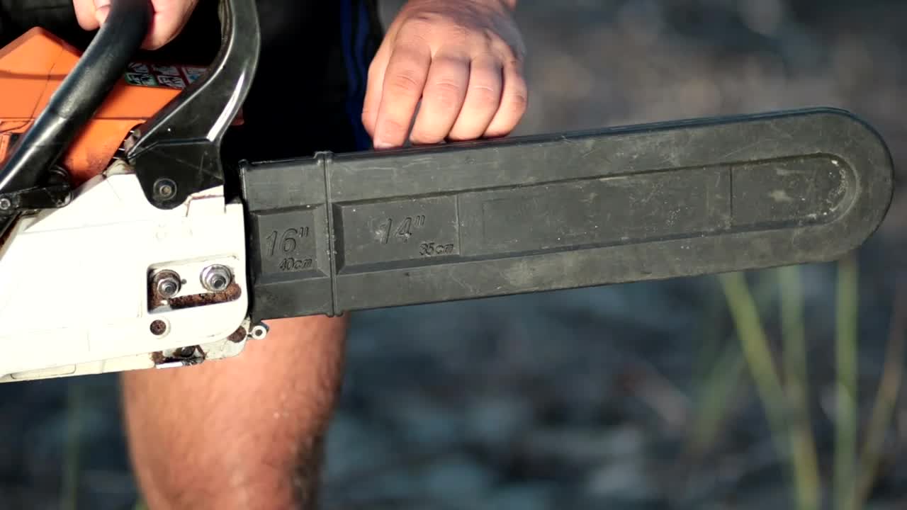 Stock Video Man Removing The Holster From A Chainsa Animated Wallpaper