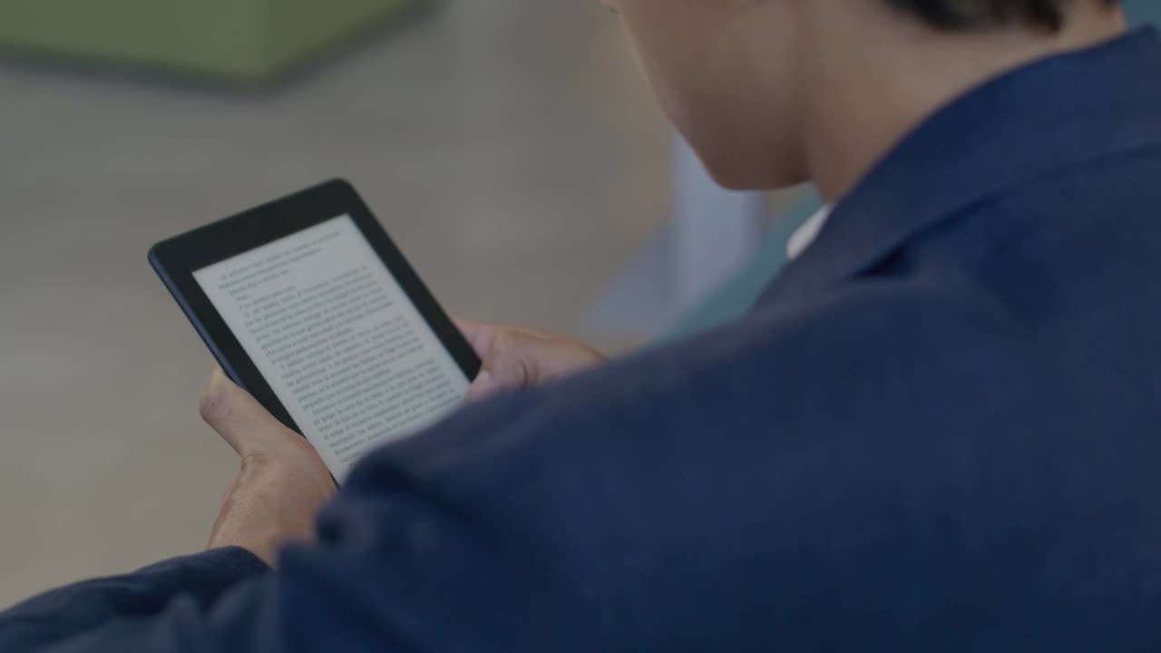 Stock Video Man Reading An Electronic Boo Animated Wallpaper