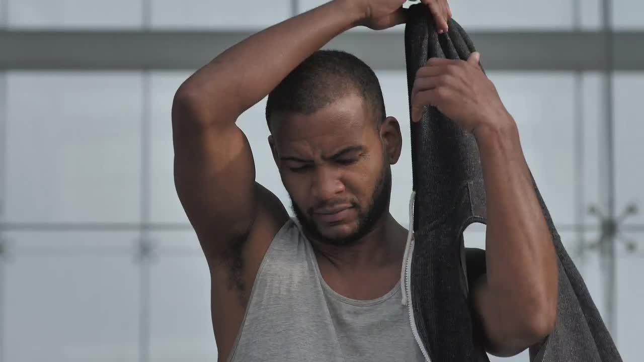 Stock Video Man Puts On Sleeveless Hoodi Animated Wallpaper