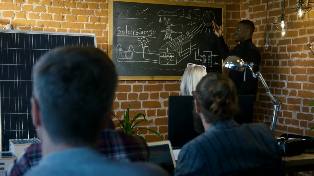 Stock Video Man Presenting Solar Technology To Small Audienc Animated Wallpaper
