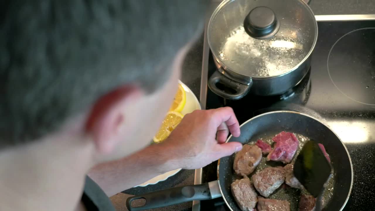 Stock Video Man Preparing Beef In A Frying Pa Animated Wallpaper