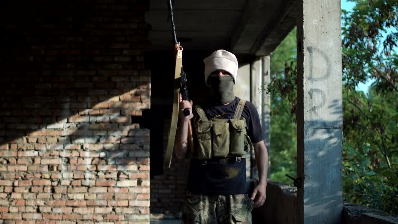 Stock Video Man Posing With A Gun On An Abandoned Sit Animated Wallpaper
