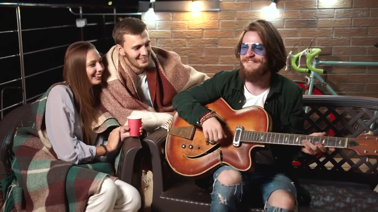 Stock Video Man Plays Guitar For Friends On Relaxing Evenin Animated Wallpaper