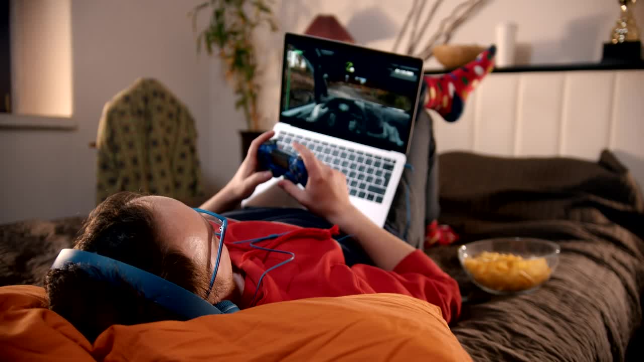 Stock Video Man Playing Video Games Lying In His Roo Animated Wallpaper