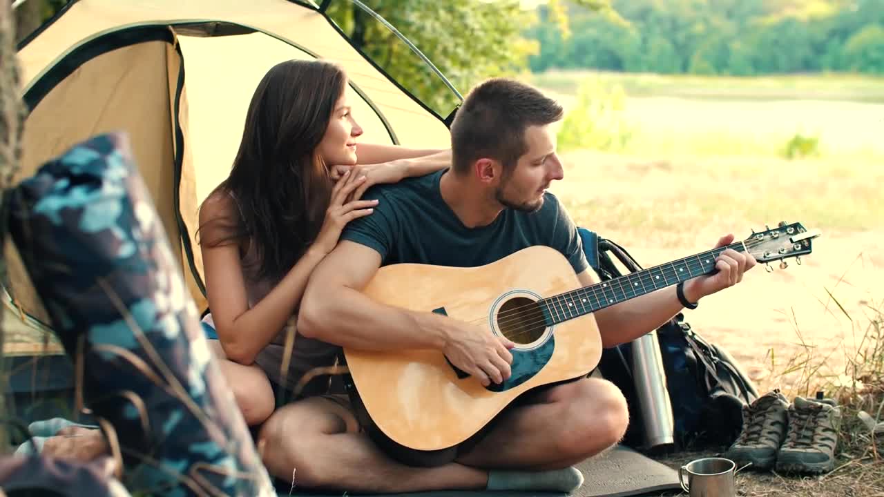 Stock Video Man Playing Guitar To His Girlfriend In Cam Animated Wallpaper