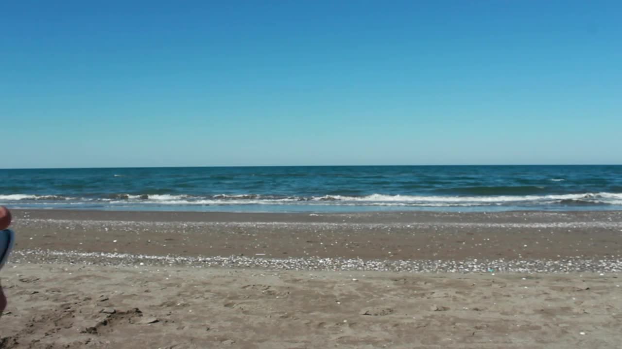 Stock Video Man Photographing The Sea In A Sunny Beac Animated Wallpaper