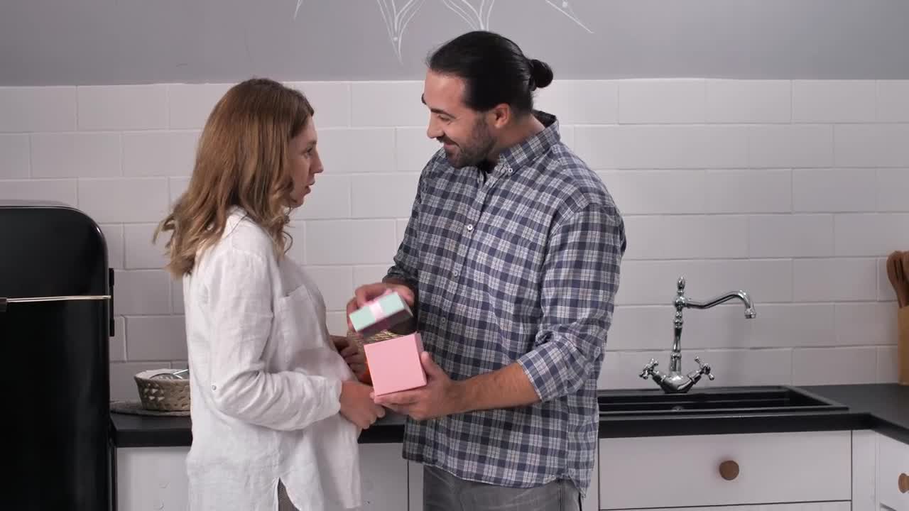 Stock Video Man Opening A Gift From His Wif Animated Wallpaper